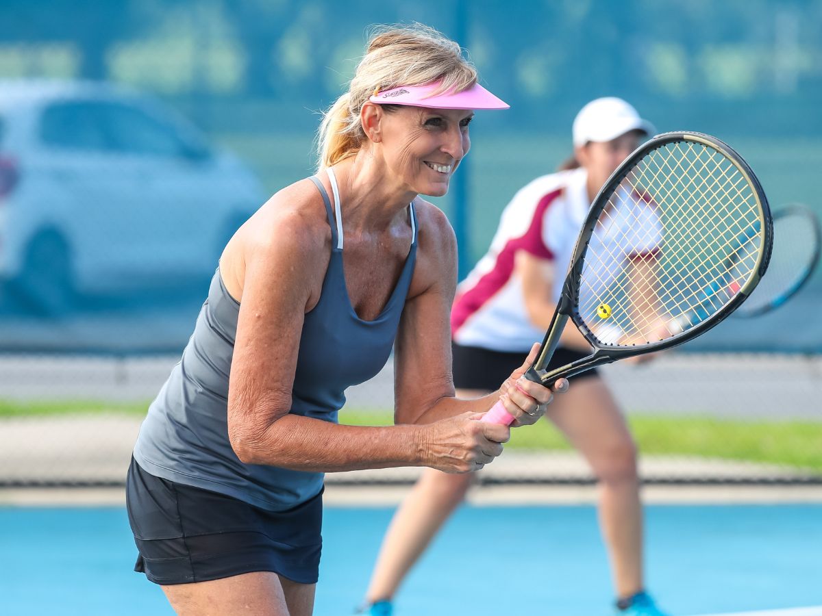 Female masters competitors waiting for the other team to serve the ball